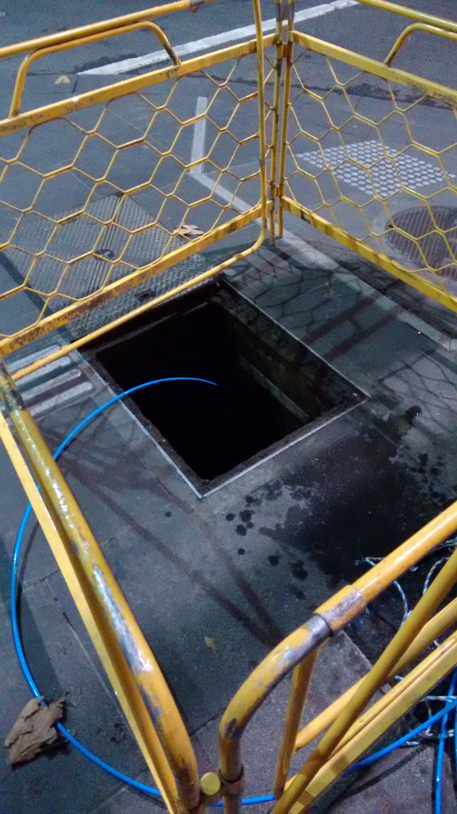 Manhole guard installed on street for safe access and worksite protection